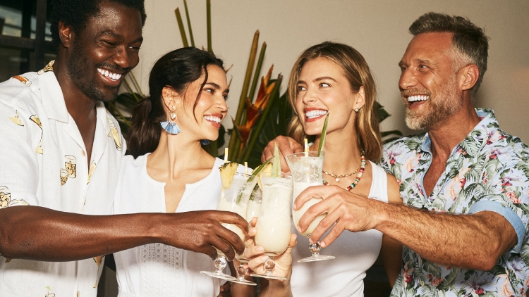 Four friends sharing drinks