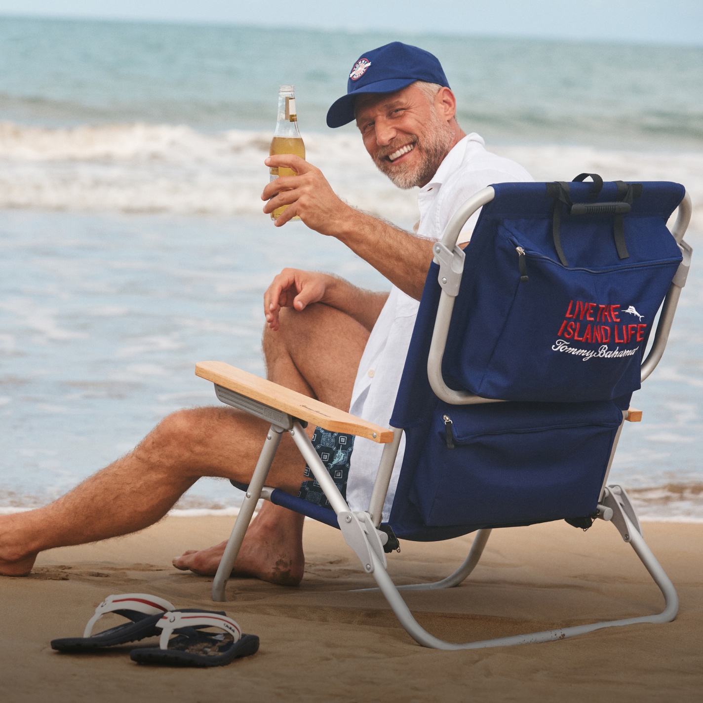 Image of man sitting on Tommy Bahama beach chair