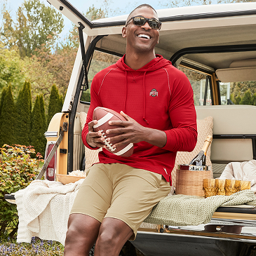 Man Wearing Fan Gear Holding A Football