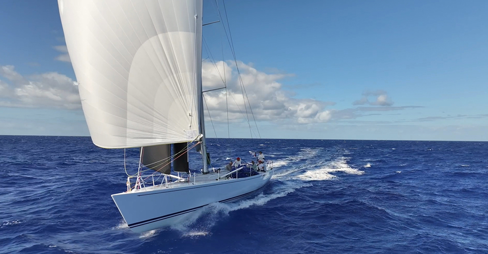 White Sailboat Coasting Along Blue Waters