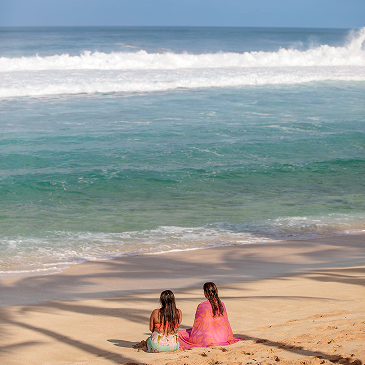 Rachael and Heather sitting on a beach