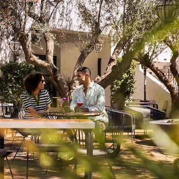 Couple enjoying drinks on modern outside patio seating
