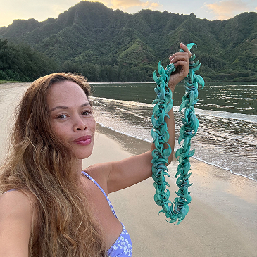 Pamakane Pico Holding An Exotic Lei Beachside