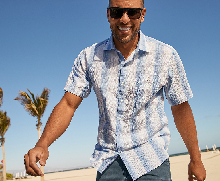 Man on the beach wearing Tommy Bahama shirt